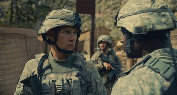 Movie still from “The Outpost” (2019), directed by Rod Lurie – A group of men standing next to each other; Medium shot, Over the shoulder angle