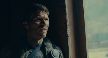 Movie still from “The Outpost” (2019), directed by Rod Lurie – A person looking out of a window; Close Up shot, Low angle