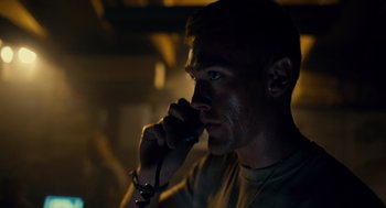 Movie still from “The Outpost” (2019), directed by Rod Lurie – A person talking on a cell phone; Close Up shot, Low angle