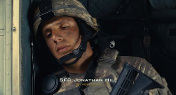 Movie still from “The Outpost” (2019), directed by Rod Lurie – A man in a military uniform holding a gun; Close Up shot, High angle