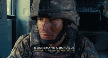 Movie still from “The Outpost” (2019), directed by Rod Lurie – A soldier wearing a helmet; Medium shot, High angle