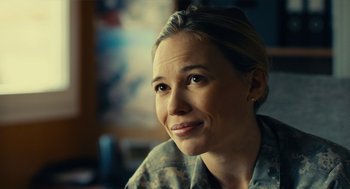 Movie still from “The Outpost” (2019), directed by Rod Lurie – A person smiling for the camera; Close Up shot, Over the shoulder angle