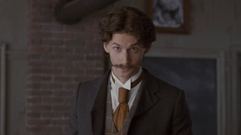Movie still from “Anne with an E” (2017), created by Moira Walley-Beckett – A man in a suit and a tie; Close Up shot, Low angle