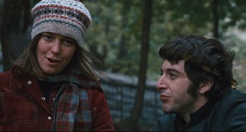 Movie still from “The Panic in Needle Park” (1971), directed by Jerry Schatzberg – A man and a woman are standing next to each other; Close Up shot, Over the shoulder angle