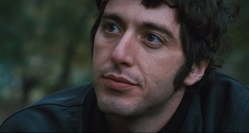 Movie still from “The Panic in Needle Park” (1971), directed by Jerry Schatzberg – A person wearing a black jacket; Close Up shot, Low angle