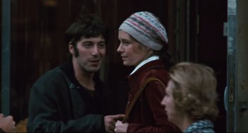Movie still from “The Panic in Needle Park” (1971), directed by Jerry Schatzberg – A group of people standing next to each other on a street; Close Up shot, Over the shoulder angle