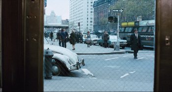 Movie still from “The Panic in Needle Park” (1971), directed by Jerry Schatzberg – A street scene with cars parked on the side of the road; Extreme Wide shot, High angle