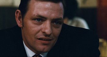 Movie still from “The Panic in Needle Park” (1971), directed by Jerry Schatzberg – A person wearing a suit and tie; Close Up shot, Low angle