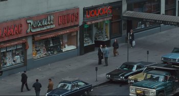 Movie still from “The Panic in Needle Park” (1971), directed by Jerry Schatzberg – A group of men standing on a street corner; Extreme Wide shot, High angle