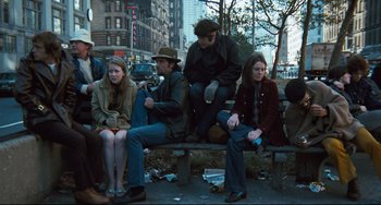 Movie still from “The Panic in Needle Park” (1971), directed by Jerry Schatzberg – A group of people sitting on top of a wooden bench; Wide shot, High angle
