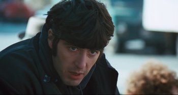 Movie still from “The Panic in Needle Park” (1971), directed by Jerry Schatzberg – A person wearing a jacket; Close Up shot, Over the shoulder angle
