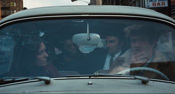 Movie still from “The Panic in Needle Park” (1971), directed by Jerry Schatzberg – A group of people sitting in the back of a car; Medium shot, Over the shoulder angle