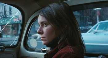 Movie still from “The Panic in Needle Park” (1971), directed by Jerry Schatzberg – A woman sitting in the back seat of a car; Close Up shot, High angle