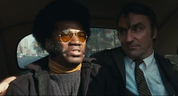 Movie still from “The Panic in Needle Park” (1971), directed by Jerry Schatzberg – A man and a man sitting in the back of a car; Close Up shot, Low angle