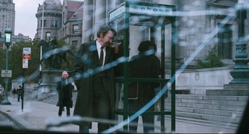 Movie still from “The Panic in Needle Park” (1971), directed by Jerry Schatzberg – A man is standing in front of a phone booth; Wide shot, Low angle