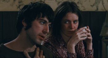 Movie still from “The Panic in Needle Park” (1971), directed by Jerry Schatzberg – A man and a woman sitting next to each other; Close Up shot, Over the shoulder angle