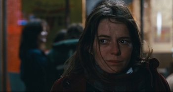 Movie still from “The Panic in Needle Park” (1971), directed by Jerry Schatzberg – A woman with long dark hair stares into the camera; Close Up shot, Over the shoulder angle