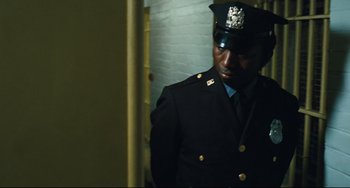 Movie still from “The Panic in Needle Park” (1971), directed by Jerry Schatzberg – A man in a military uniform standing in a room; Medium shot, Over the shoulder angle