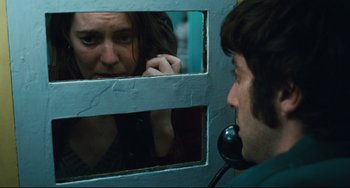Movie still from “The Panic in Needle Park” (1971), directed by Jerry Schatzberg – A woman looking in the mirror while talking on the phone; Close Up shot, Over the shoulder angle