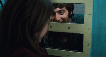 Movie still from “The Panic in Needle Park” (1971), directed by Jerry Schatzberg – A man and a woman looking at each other in a mirror; Close Up shot, Over the shoulder angle