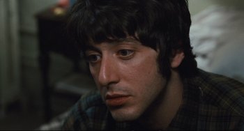 Movie still from “The Panic in Needle Park” (1971), directed by Jerry Schatzberg – A person wearing a plaid shirt; Close Up shot, High angle