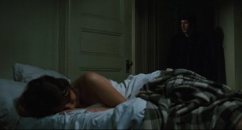 Movie still from “The Panic in Needle Park” (1971), directed by Jerry Schatzberg – A woman laying on a bed next to a man; Medium shot, Over the shoulder angle