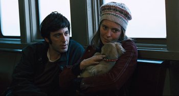 Movie still from “The Panic in Needle Park” (1971), directed by Jerry Schatzberg – A man and a woman holding a small dog; Medium shot, Over the shoulder angle