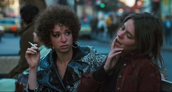 Movie still from “The Panic in Needle Park” (1971), directed by Jerry Schatzberg – Two women standing next to each other on the street; Close Up shot, Over the shoulder angle