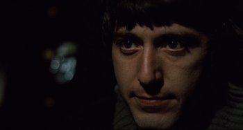 Movie still from “The Panic in Needle Park” (1971), directed by Jerry Schatzberg – A man's face in the dark; Close Up shot, Low angle