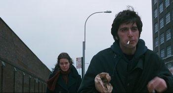 Movie still from “The Panic in Needle Park” (1971), directed by Jerry Schatzberg – A man and a woman walking down a street; Close Up shot, Low angle