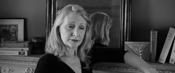 Movie still from “The Party” (2017), directed by Sally Potter – A black and white photo of a woman in front of a mirror; Close Up shot, Low angle