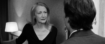 Movie still from “The Party” (2017), directed by Sally Potter – An older woman is looking at a younger man; Close Up shot, Over the shoulder angle