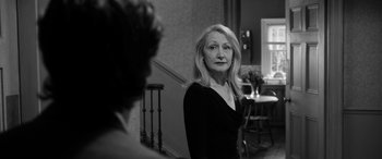 Movie still from “The Party” (2017), directed by Sally Potter – An older woman standing in front of a mirror; Close Up shot, Over the shoulder angle