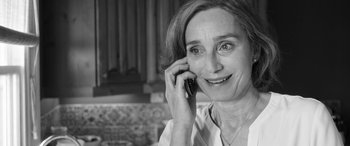 Movie still from “The Party” (2017), directed by Sally Potter – A woman talking on a cell phone while sitting down; Close Up shot, Over the shoulder angle