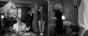 Movie still from “The Party” (2017), directed by Sally Potter – A group of people standing in a living room; Wide shot, Low angle