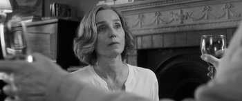 Movie still from “The Party” (2017), directed by Sally Potter – Black and white photograph of a woman in front of a fireplace; Close Up shot, Over the shoulder angle