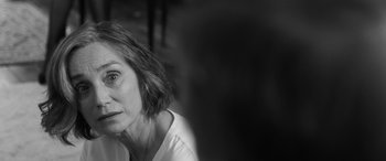 Movie still from “The Party” (2017), directed by Sally Potter – Black and white photograph of an older woman looking at the camera; Close Up shot, Over the shoulder angle