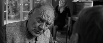 Movie still from “The Party” (2017), directed by Sally Potter – An older man and a woman in a room; Close Up shot, Over the shoulder angle