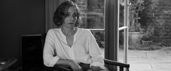 Movie still from “The Party” (2017), directed by Sally Potter – Black and white photograph of a woman sitting in a chair; Close Up shot, Over the shoulder angle
