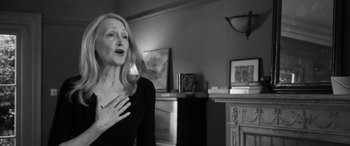 Movie still from “The Party” (2017), directed by Sally Potter – A black and white photo of a woman holding her hand to her chest; Close Up shot, Over the shoulder angle