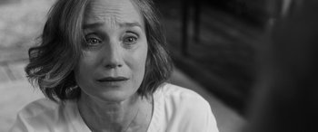 Movie still from “The Party” (2017), directed by Sally Potter – Black and white photograph of an older woman looking sad; Close Up shot, Over the shoulder angle