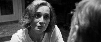 Movie still from “The Party” (2017), directed by Sally Potter – A black - and - white photo of a woman looking at the camera; Close Up shot, Over the shoulder angle