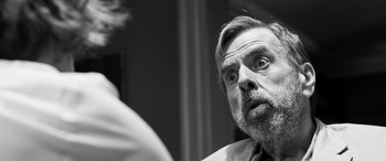 Movie still from “The Party” (2017), directed by Sally Potter – Black and white photograph of a man looking at himself in the mirror; Close Up shot, Over the shoulder angle