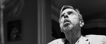 Movie still from “The Party” (2017), directed by Sally Potter – An older man looking up into the sky; Close Up shot, Low angle