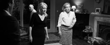 Movie still from “The Party” (2017), directed by Sally Potter – Two women standing next to each other in a living room; Medium shot, Over the shoulder angle