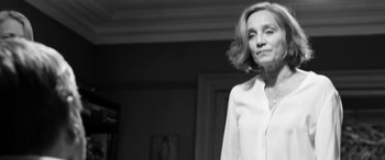Movie still from “The Party” (2017), directed by Sally Potter – Black and white photograph of a woman wearing a white shirt; Close Up shot, Low angle
