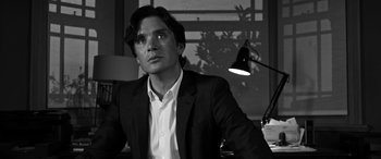 Movie still from “The Party” (2017), directed by Sally Potter – Black and white photograph of a man wearing a suit; Close Up shot, Low angle