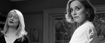 Movie still from “The Party” (2017), directed by Sally Potter – A black - and - white photo of a woman in front of a window; Close Up shot, Over the shoulder angle