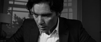 Movie still from “The Party” (2017), directed by Sally Potter – Black and white photograph of a man in a suit; Close Up shot, Low angle