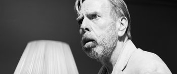 Movie still from “The Party” (2017), directed by Sally Potter – An older man with a beard and mustache looking at the camera; Close Up shot, Over the shoulder angle